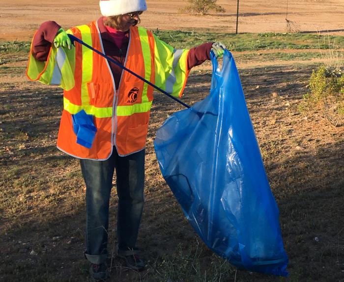 Adopt a Highway volunteer wearing Santa hat