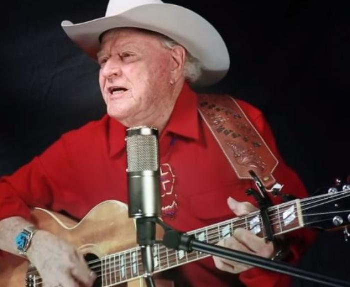 State balladeer Dolan Ellis plays guitar and sings