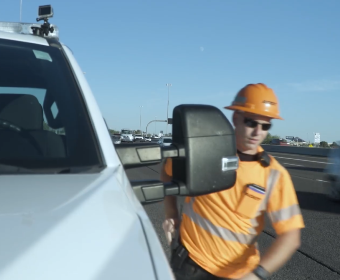Incident Response Unit member exits his truck along freeway.