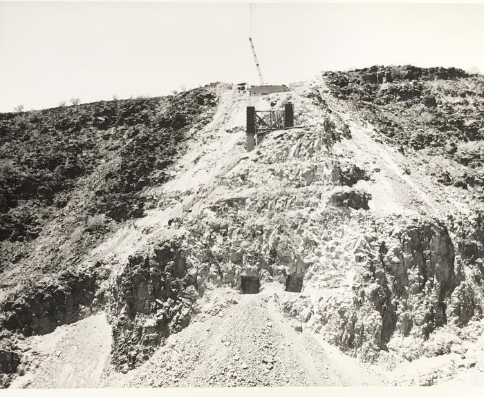 Black and white image of construction work done on a steep hill