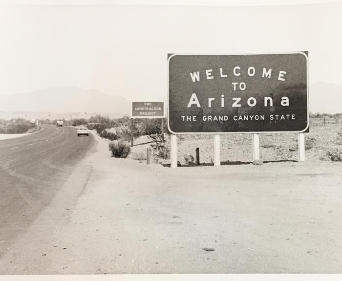 Black and white image of a "Welcome to Arizona" sign