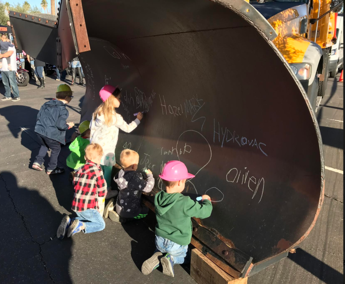 Youngsters are signing their names on ADOT's front-end snowplow