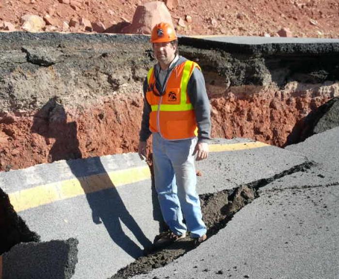 Patrice Brun at site of road damaged by earth movement