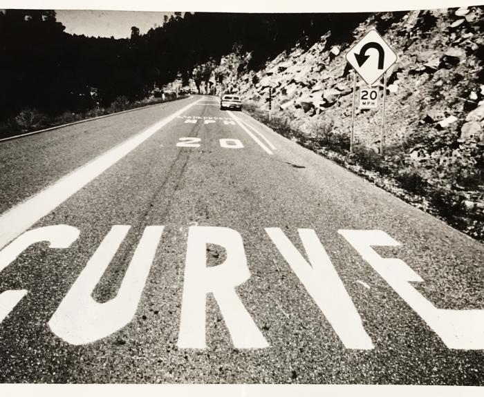 Image of SR 87 with curve warning painted on road