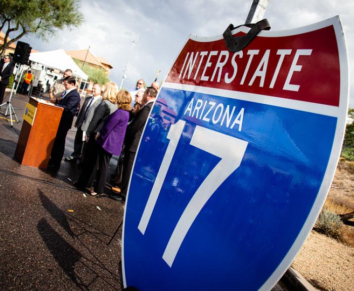 A metal Interstate 17 sign displayed at a news conference