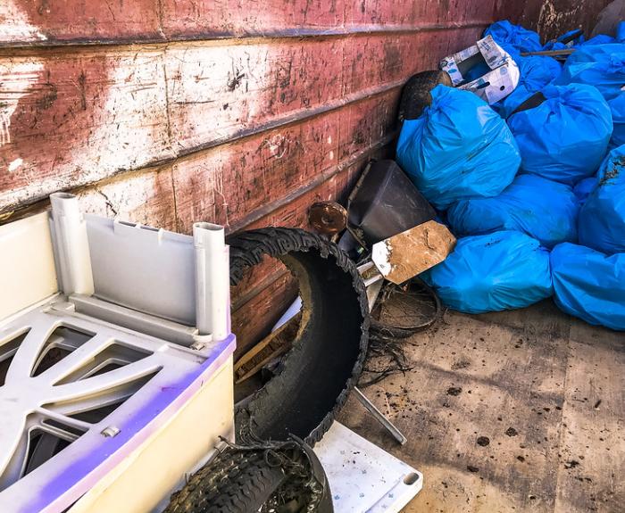 A pile of stocked up road litter in blue bags