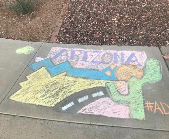 Adot kids chalk art graphic on a sidewalk.