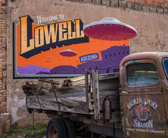 Mural on side of brick building welcomes people to Lowell.