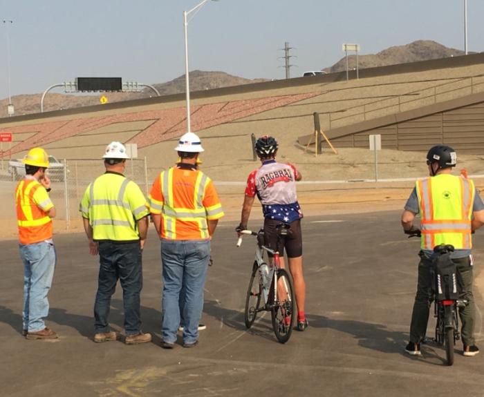 ADOT workers talk with a bicyclist