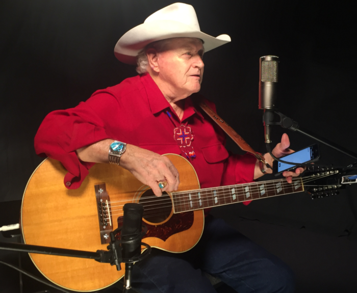 Dolan Ellis suings and strums his guitar.