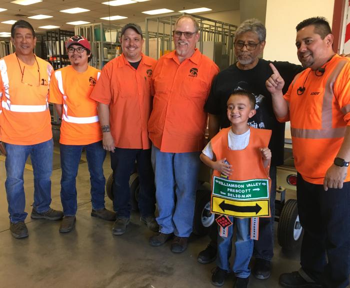 Highway Sign Shop Personnel with a little boy on his tour