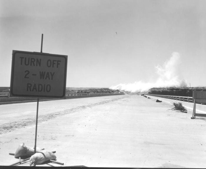 Black and white image of a sign that reads "Turn off 2-way radio"