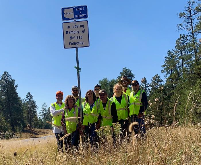 Adopt a Highway sign and group of volunteers