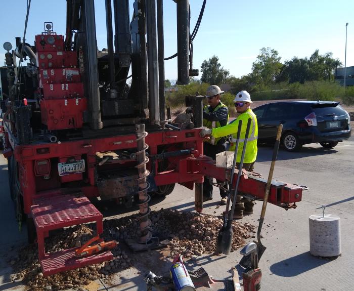 Workers operate large drill