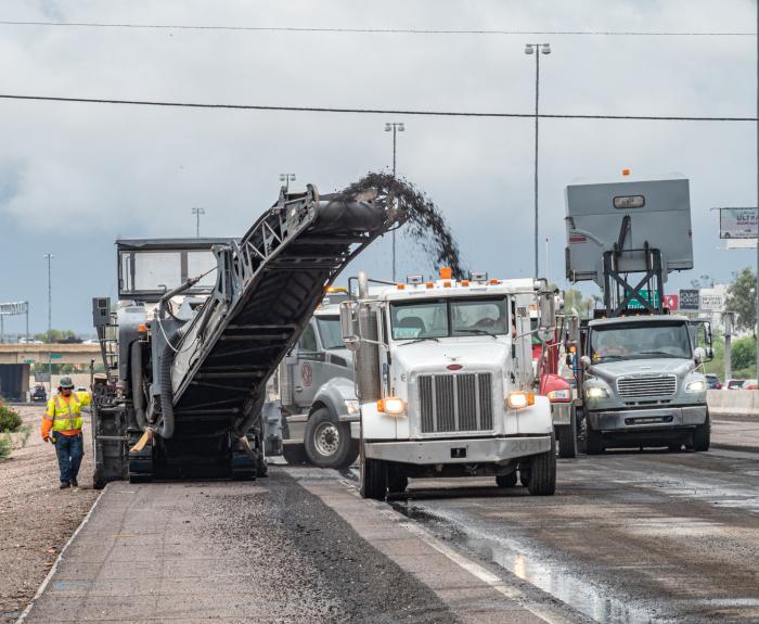 Equipment removing asphalt and conveying it into a truck trailer