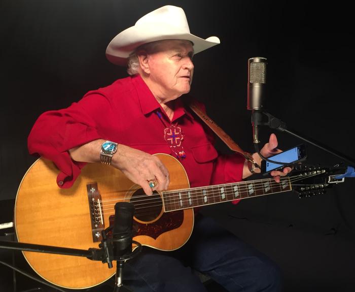 Dolin Ellis with guitar and microphone