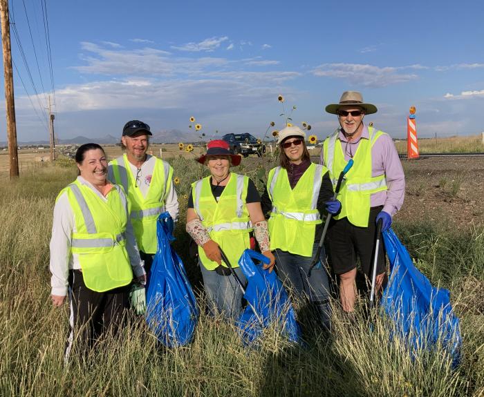 Adopt a Highway volunterrs pose along highway.