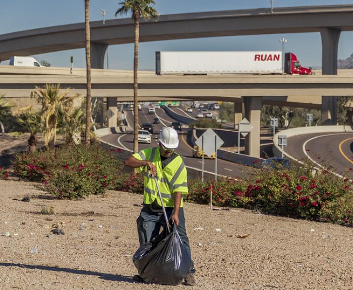 ADOT maintenance crew member collecting litter along Maricopa County freeways
