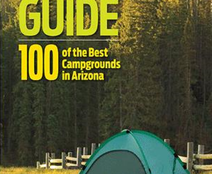 A green tent set up in a grassy area surrounded by trees; cover of Arizona Highways Camping Guide book.