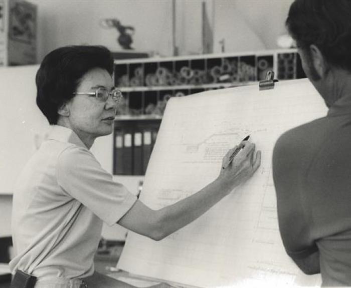 Frances Walker works at a drafting board.