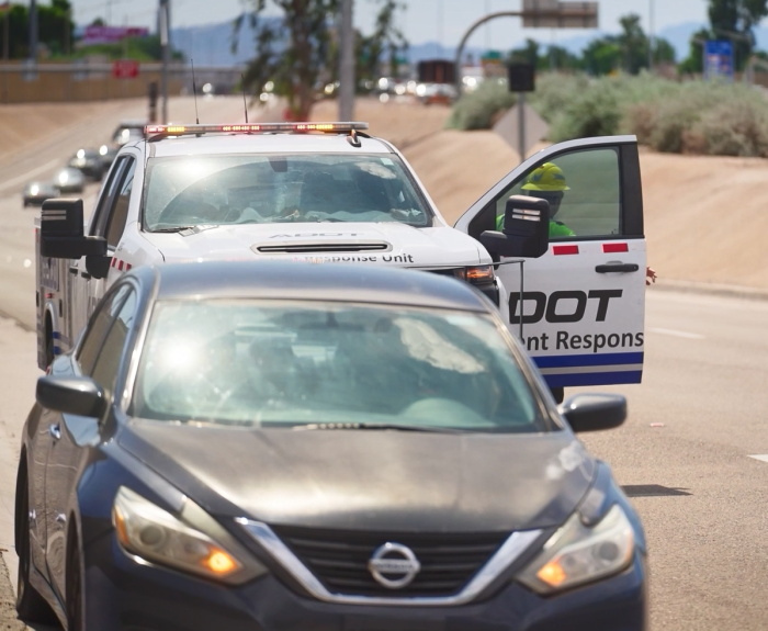 An ADOT Incident Response Unit member assisting a stranded motorist.