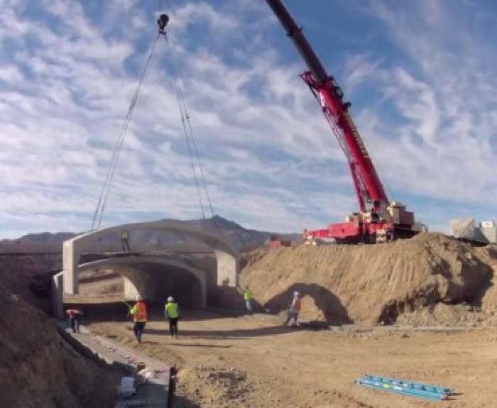 Crane installs concrete tunnel for wildlife underpass