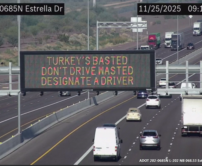 A digital message board on the highway encourages motorists to designate a driver.