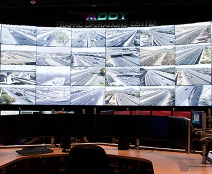 Traffic Operations Center wall covered with monitors showing traffic