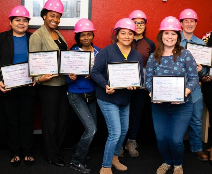Construction academy graduates pose with certificates