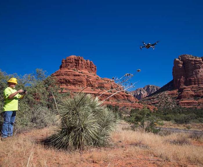 A drone pilot operates a drone in Sedona