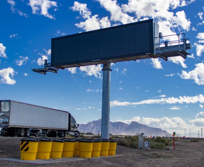 Truck drives past message board in I-10 dust detection system