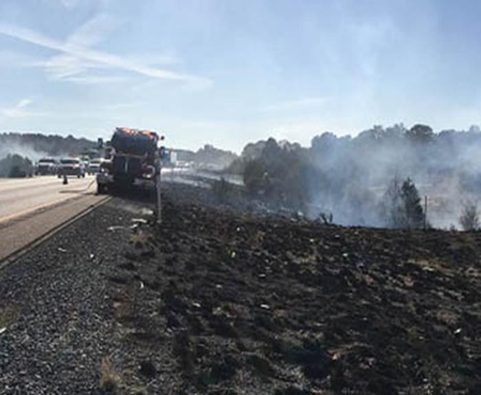 Still-smoldering fire along freeway