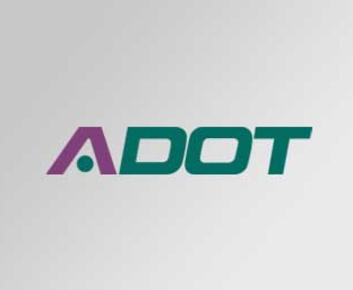 ADOT logo with a stylized purple A and green DOT on a light gray gradient background.