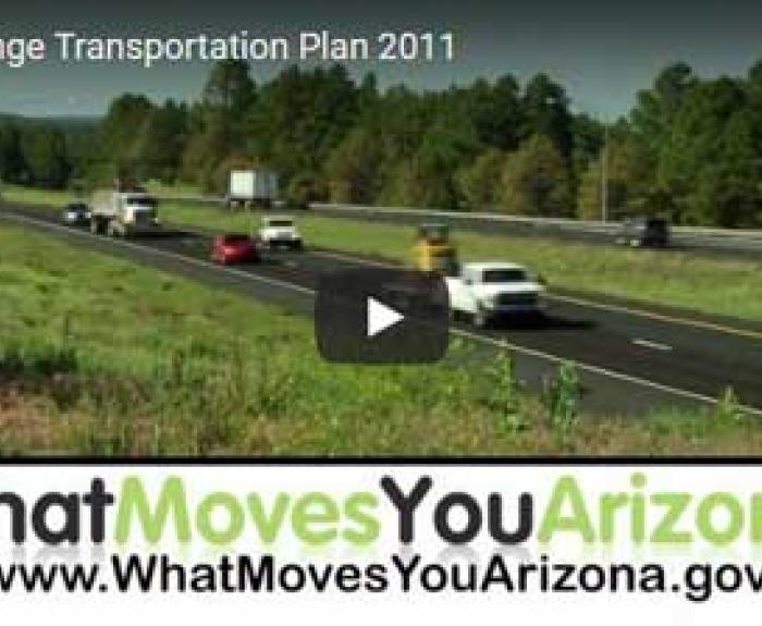 Several vehicles travel on a divided highway bordered by trees, with a banner at the bottom reading What Moves You Arizona and a website URL.
