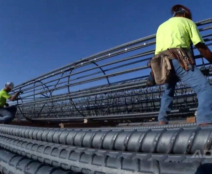 Workers with a rebar cage