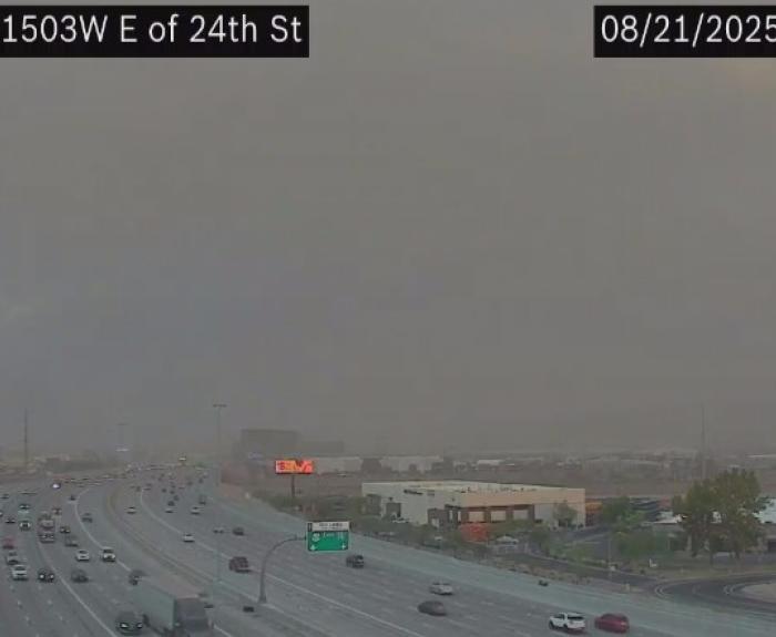 Traffic camera view of blowing dust on urban freeway