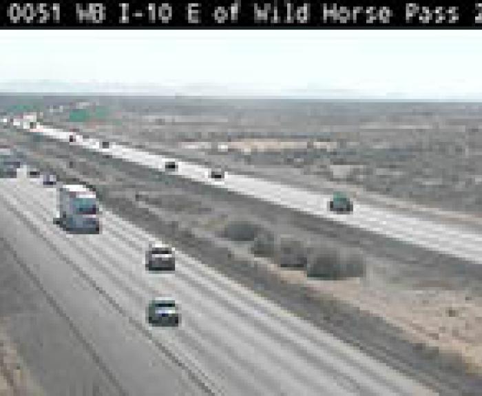 Traffic on Interstate 10 east of Wild Horse Pass, showing several vehicles traveling in both directions on a wide highway through a desert landscape.