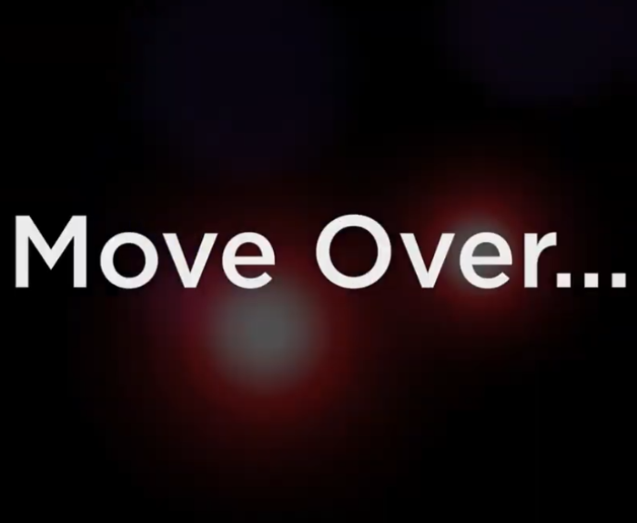 White text reading Move Over... appears centered on a dark background with faint, blurred red and white lights behind the text.