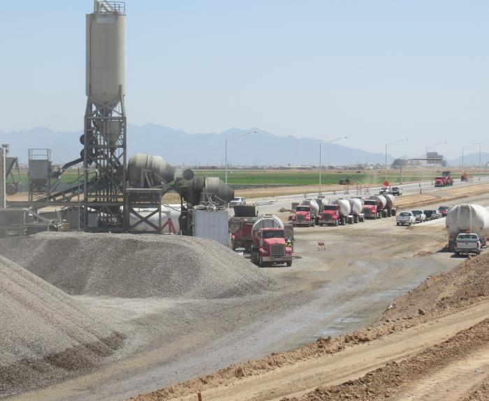 Line of cement trucks entering batch plant
