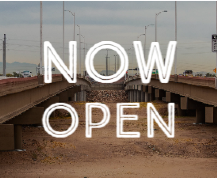 View of South Mountain Freeway with words Now Open over it