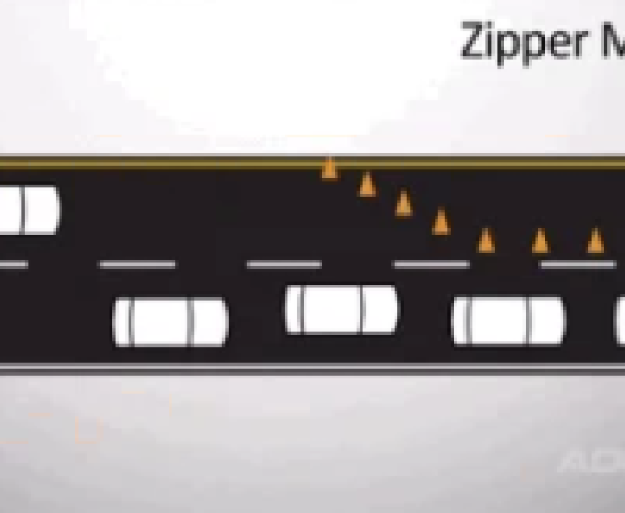 Diagram showing cars using a zipper merge at a lane closure, with traffic cones blocking one lane and vehicles alternating to merge into the open lane.