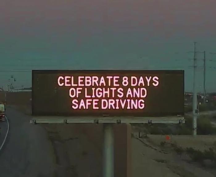 A digital message board on the highway encourages motorists to drive safe.