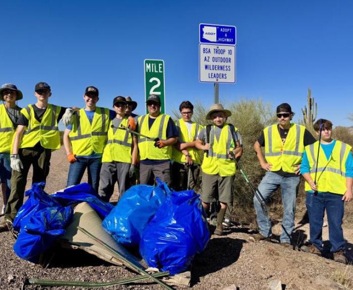 Scouts pose with litter bags after cleanup.