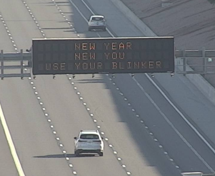 A digital message board on the highway encourages motorists to use their blinker.
