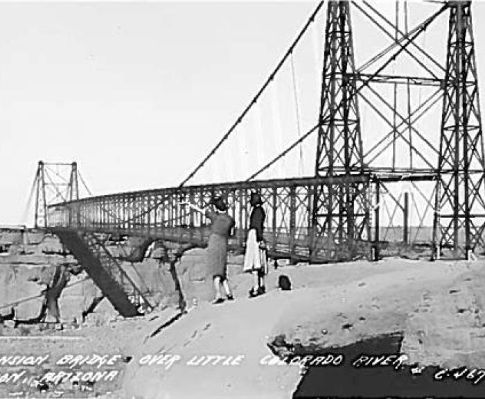 Postcard image of two women looking at bridge