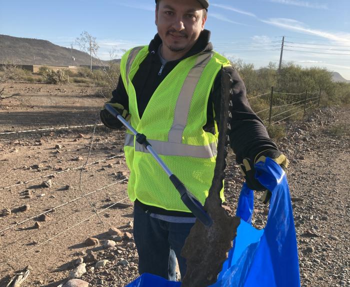Volunteer picking up trash on SR 74