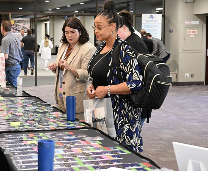 Attendee stands at table at last year's event