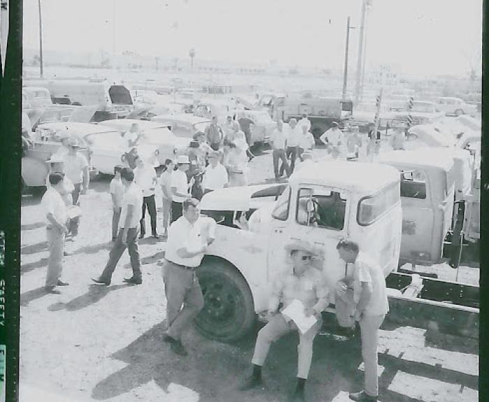 Old auction with trucks and people