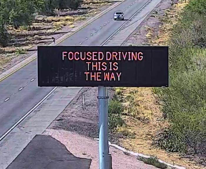 A digital message board on the highway encourages motorists to drive focused.