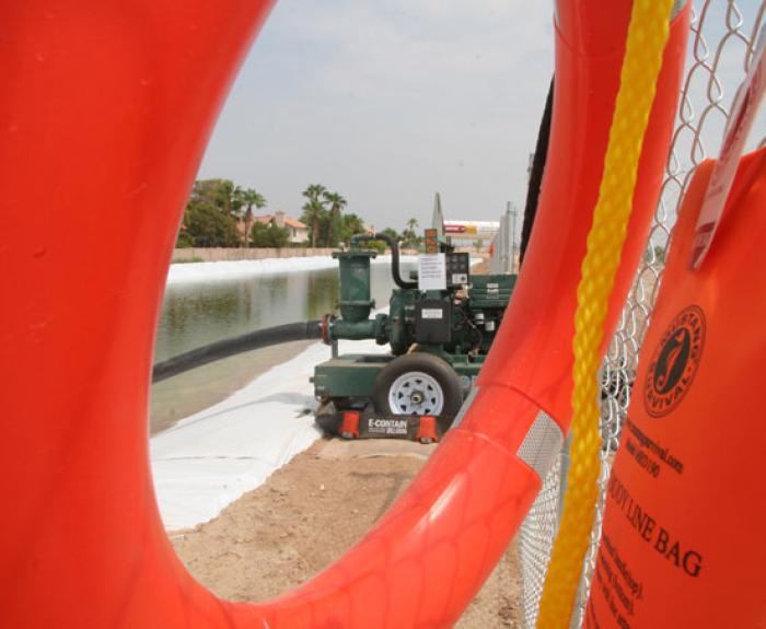 Construction pond seen through life preserver ring